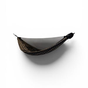 May include: A hammock with a black and gold patterned fabric, suspended against a white background. The hammock has a dark mesh net and is designed for outdoor relaxation. The hammock is lightweight and portable.