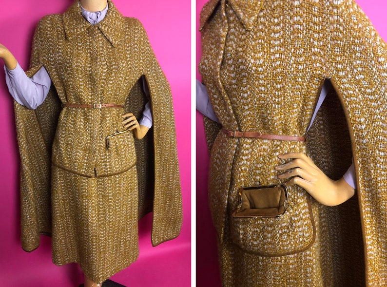 May include: A brown and white tweed cape with a brown leather belt and a small pocket on the front. The cape has a long, flowing design and is perfect for a vintage look.