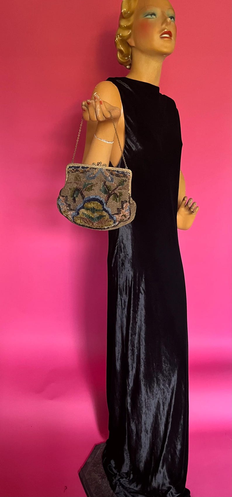 May include: A vintage beaded evening bag with a chain strap. The bag is decorated with floral and geometric patterns in shades of brown, green, blue, and pink.