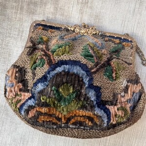 May include: A vintage embroidered purse with a gold metal clasp and chain. The purse is made of a brown fabric with colorful floral embroidery.