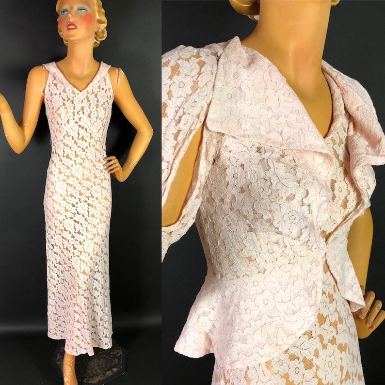 May include: A delicate pink lace dress with a ruffled collar and a fitted bodice. The dress has a sleeveless design and a flowing skirt.