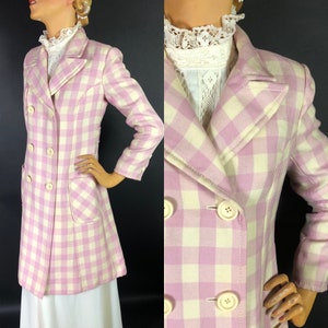 May include: A long, pink and white gingham double-breasted coat with a collar and pockets.