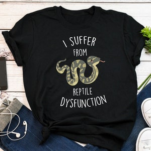 May include: Black t-shirt with a white graphic of a snake and the text "I suffer from reptile dysfunction".