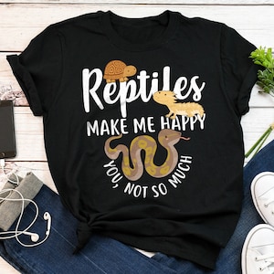 May include: Black t-shirt with white text that reads "Reptiles make me happy, you not so much". The shirt features a cartoon turtle, lizard, and snake.