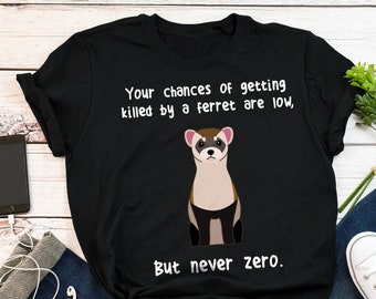 May include: Black t-shirt with a white graphic of a ferret and the text "Your chances of getting killed by a ferret are low, But never zero."