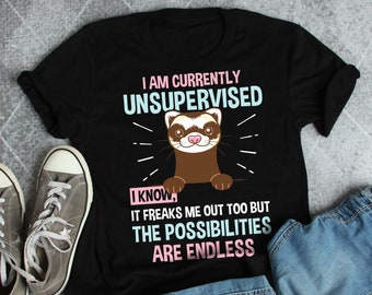 May include: Black t-shirt with a ferret graphic and the text "I AM CURRENTLY UNSUPERVISED." The shirt also says "I KNOW, IT FREAKS ME OUT TOO BUT THE POSSIBILITIES ARE ENDLESS." Gray canvas sneakers and denim shorts are also in the image.