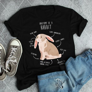 May include: A black t-shirt featuring a white graphic of a rabbit with the text "Anatomy of a Rabbit" and various humorous anatomical labels.