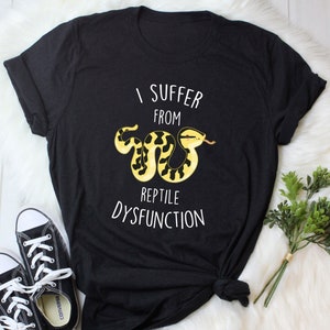 May include: Black t-shirt with a white graphic of a snake and the text "I suffer from reptile dysfunction".