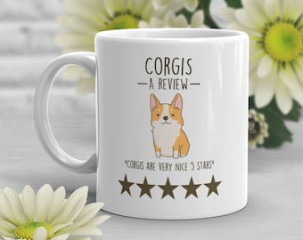May include: White ceramic mug featuring a cartoon corgi and the text "Corgis - A Review - "Corgis are very nice 5 stars" with five gold stars.