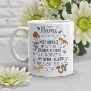 May include: White ceramic mug with a blue and brown illustration of reptiles and the text "THINGS Name DOES IN THEIR SPARE TIME"  *HOLDS REPTILES *BUYS REPTILES *RESEARCHES REPTILES *TALKS ABOUT REPTILES CLEANS REPTILE ENCLOSURES THINKS ABOUT REPTILES