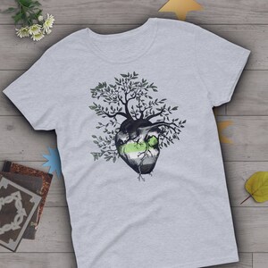 May include: A gray t-shirt with a green, white, and gray heart with a tree growing out of it. The heart is a representation of the ace flag.