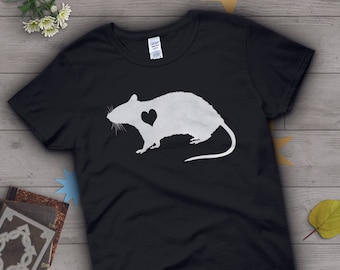 May include: Black t-shirt with a white silhouette of a rat with a heart inside. The rat is facing left and has a long tail.
