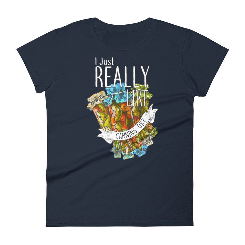 May include: A navy blue women's t-shirt with the text "I Just Really Like Canning, Ok?" in white. The shirt features a colorful illustration of jars of preserved food.
