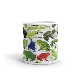 May include: White ceramic mug with a colorful pattern of frogs and toads. The mug features a variety of frog species in different colors and poses.