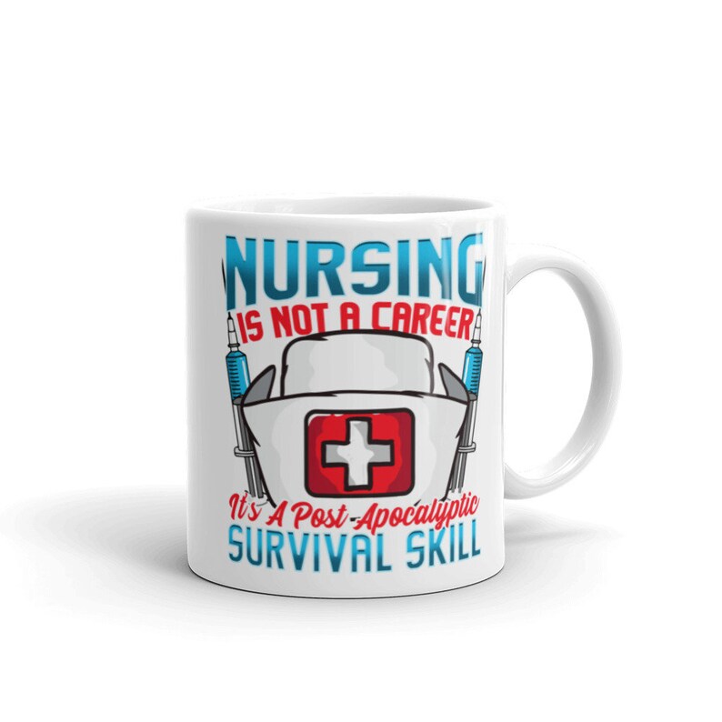 May include: White ceramic mug with a blue and red graphic that says "Nursing is not a career, it's a post-apocalyptic survival skill". The graphic includes a nurse's hat with a red cross and two syringes.