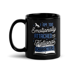 May include: Black ceramic mug with a white unicorn and blue text that reads "I am too emotionally attached to fictional characters".