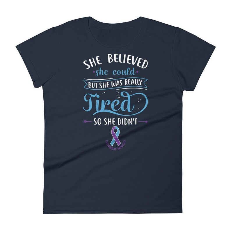 May include: Navy blue women's t-shirt with the text "She believed she could, but she was really tired, so she didn't."  The text is in a light blue color with a purple ribbon below it that says "Bipolar Awareness".