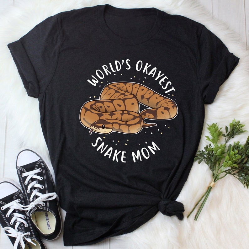 May include: Black t-shirt with a white graphic of a snake and the text "World's Okayest Snake Mom".
