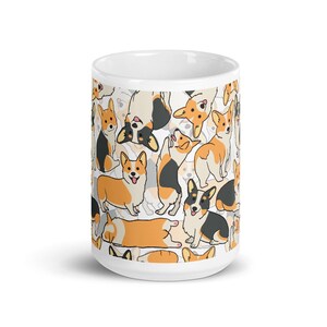 May include: White ceramic mug with a pattern of cartoon corgis in various poses. The corgis are black, white, and orange.
