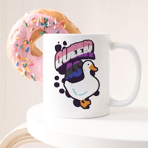May include: White ceramic mug with a black and white illustration of a goose and the text "Queer as" in rainbow colors.