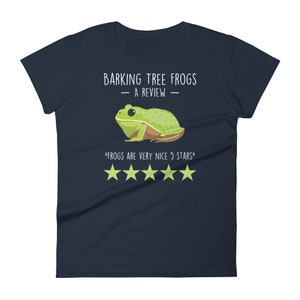 May include: A navy blue t-shirt with a green tree frog illustration and the text "Barking Tree Frogs - A Review - "Frogs are very nice 5 stars" with five gold stars.