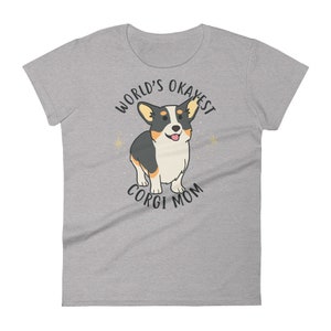 May include: Gray t-shirt with a cartoon corgi dog and the text "World's Okayest Corgi Mom".
