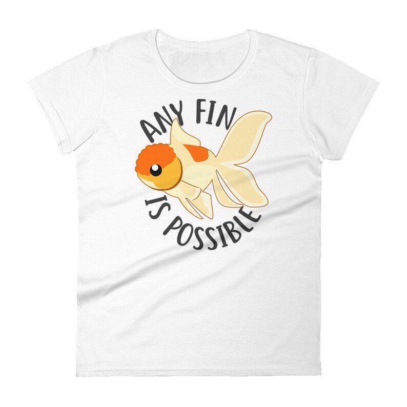May include: White women's t-shirt with a cartoon goldfish and the text "Any fin is possible."