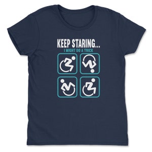 May include: Navy blue t-shirt with the text "KEEP STARING... I MIGHT DO A TRICK" and four white icons of a person in a wheelchair, one in each of the four possible positions.