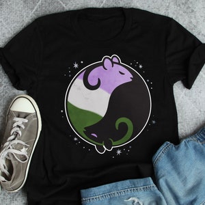 May include: A black t-shirt with a yin yang symbol featuring two mice. The mice are purple, green, and white, representing the colors of the gender-neutral pride flag.