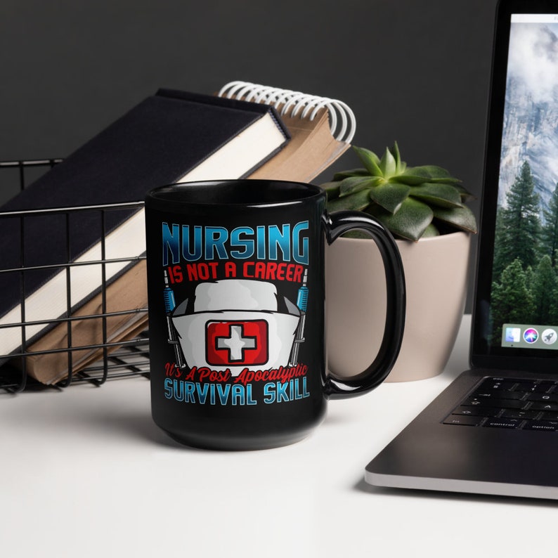 May include: Black ceramic mug with a white and red graphic that says "Nursing is not a career it's a post apocalyptic survival skill".