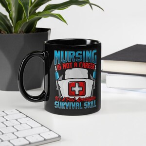 May include: Black ceramic mug with a white and red graphic that says "Nursing is not a career, it's a post-apocalyptic survival skill". The graphic also includes a red cross and two syringes.