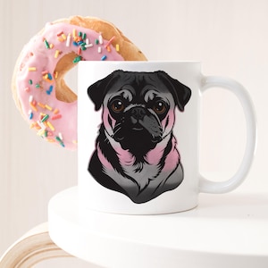 May include: White ceramic mug featuring a black pug illustration with pink accents. A pink frosted donut with colorful sprinkles is in the background. The mug has a curved handle.