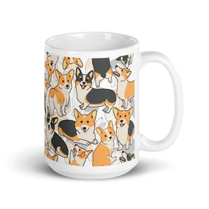 May include: White ceramic mug with a pattern of cartoon corgis in various poses. The corgis are black, white, and orange.