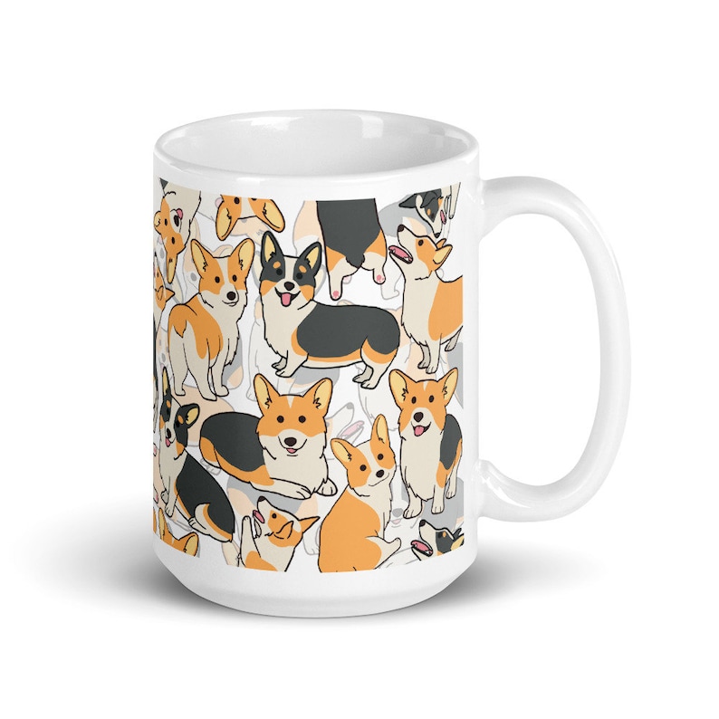 May include: White ceramic mug with a pattern of cartoon corgis in various poses. The corgis are black, white, and orange.