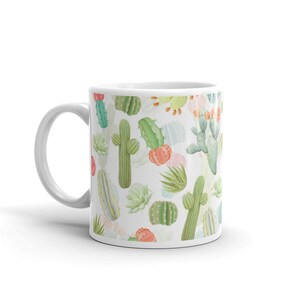 May include: White ceramic mug with a colorful cactus pattern. The mug features a variety of cacti in shades of green, pink, and orange.