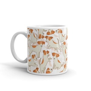 May include: White ceramic mug with a pattern of brown and white Jack Russell terriers. The dogs are in various poses, including sitting, standing, and jumping.