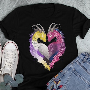 May include: Black t-shirt featuring a graphic of two dragons forming a heart shape. The dragons are coloured yellow, purple, white, and pink, representing the colours of the genderqueer pride flag.