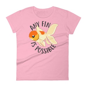 May include: Pink women's t-shirt with a cartoon goldfish and the text "Any fin is possible."