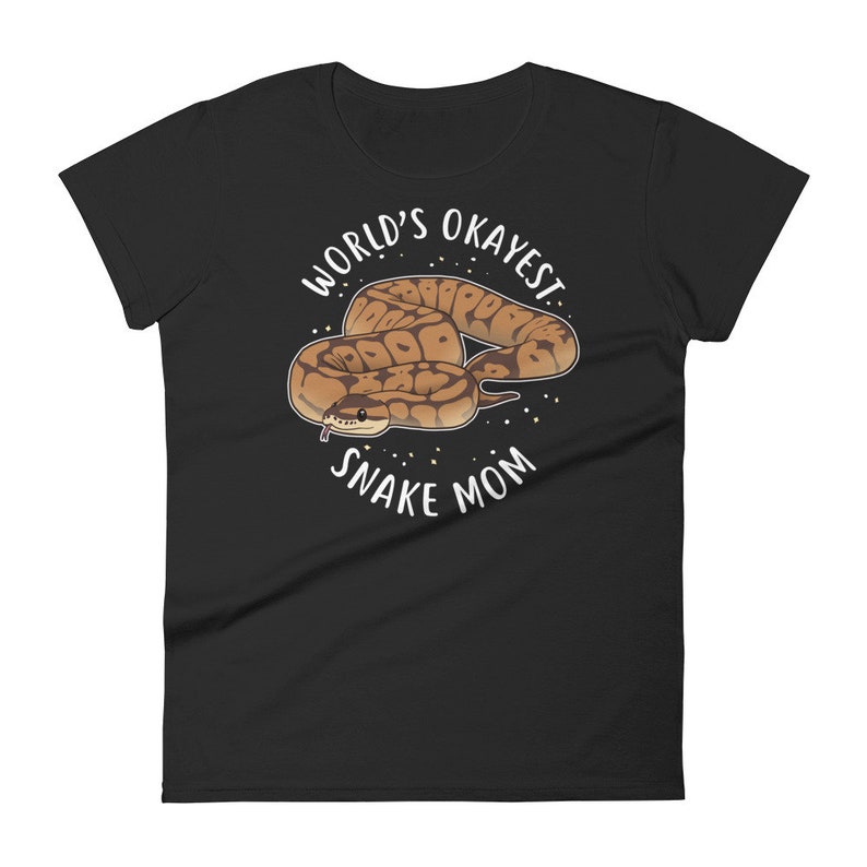 May include: Black women's t-shirt with white text that reads "World's Okayest Snake Mom" and a cartoon image of a brown and tan snake.