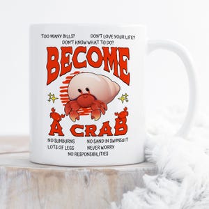 May include: White ceramic mug with a humorous design. The mug features the words "BECOME A CRAB" in red, along with a cartoon crab illustration. Additional text includes phrases like "No Sunburns" and "No Responsibilities."