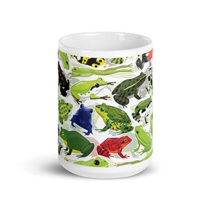 May include: White ceramic mug with a colorful pattern of frogs in various poses and colors. The frogs are green, red, blue, black, and yellow.