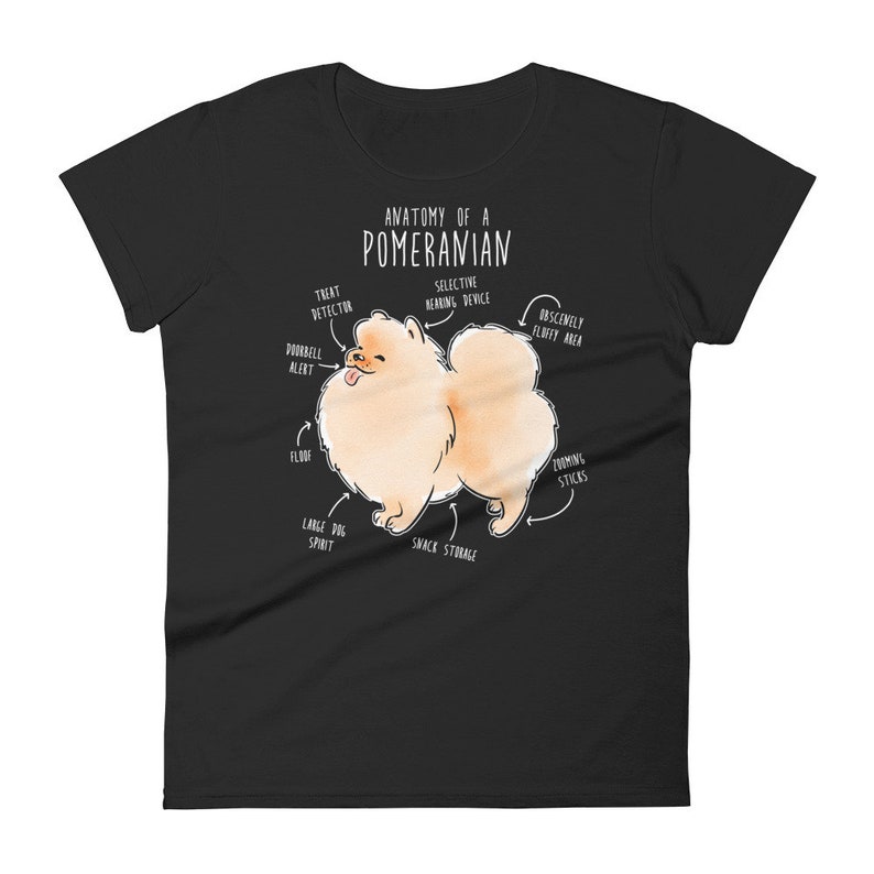 K&ouml;nnte beinhalten: Ein schwarzes T-Shirt mit einer wei&szlig;en Illustration eines Zwergspitz-Hundes. Die Illustration ist mit humorvollen anatomischen Merkmalen beschriftet, wie "Leckerli-Detektor", "Obsz&ouml;n flauschiger Bereich" und "Snack-Lagerung".