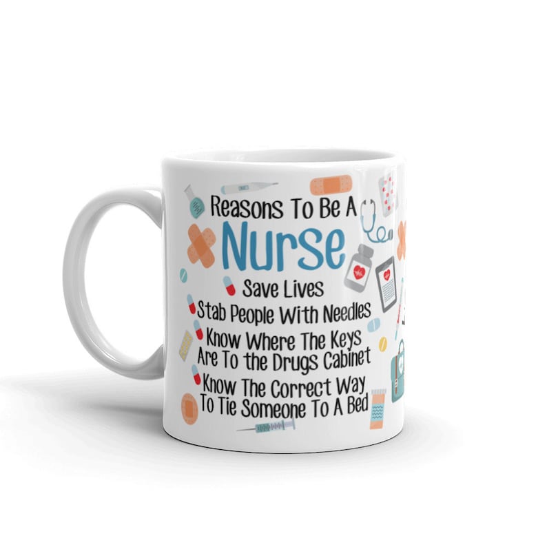 May include: White ceramic coffee mug with a blue and red design. The mug features the text "Reasons To Be A Nurse" and a list of reasons, including "Save Lives", "Stab People With Needles", and "Know Where The Keys Are To The Drugs Cabinet".