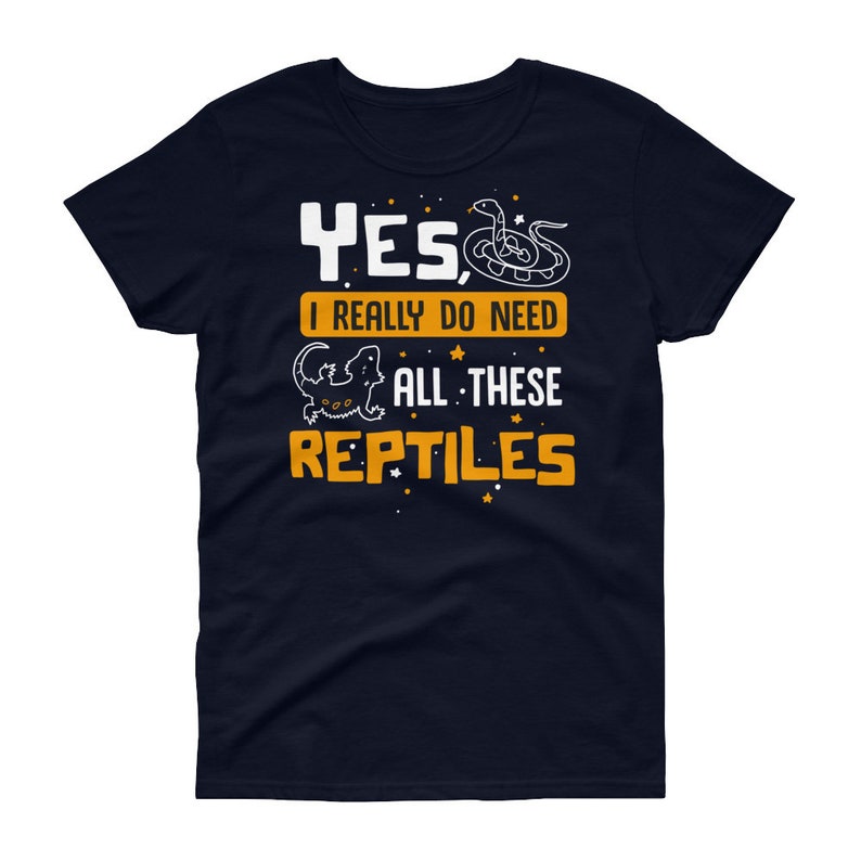 May include: A navy blue t-shirt with a white graphic of a snake and a lizard. The text on the shirt reads "Yes, I really do need all these reptiles".
