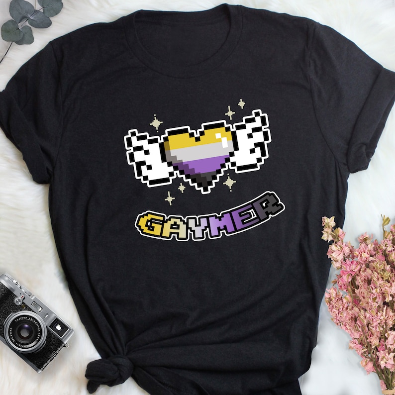 a black t - shirt with a pixel heart and the word emd on it