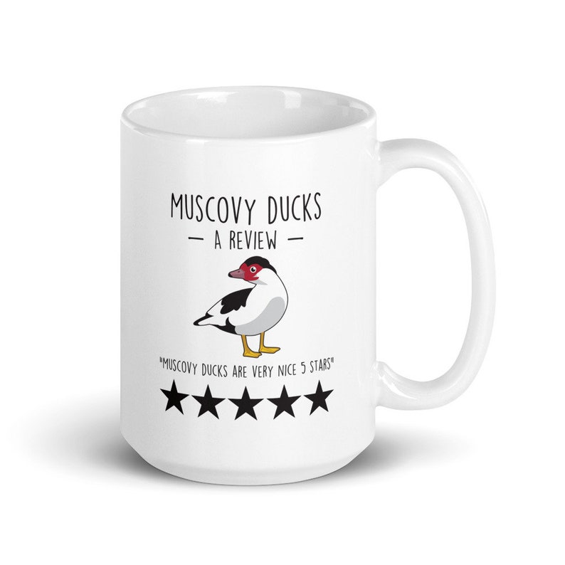 May include: White ceramic mug with a black and white illustration of a Muscovy duck. The text "Muscovy Ducks - A Review -" is printed on the mug, along with the text "Muscovy Ducks are very nice 5 stars" and five black stars.