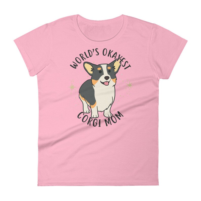 May include: Pink women's t-shirt with a cartoon corgi and the text "World's Okayest Corgi Mom"