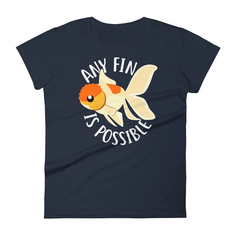 May include: Navy blue women's t-shirt with a white goldfish illustration and the text "Any fin is possible".