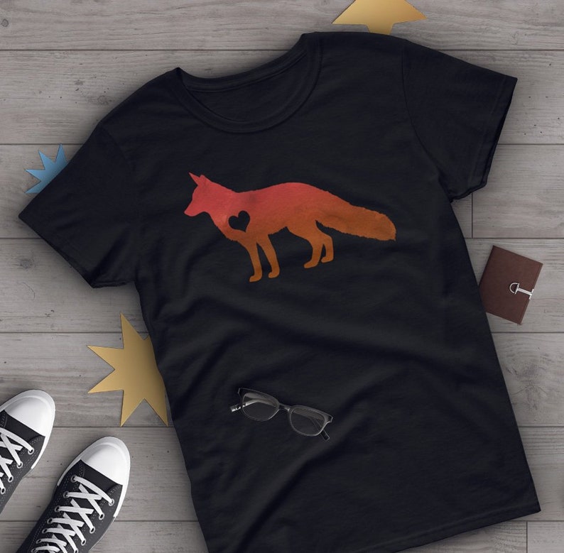May include: A black t-shirt with a red, orange, and yellow silhouette of a fox with a heart in its chest.