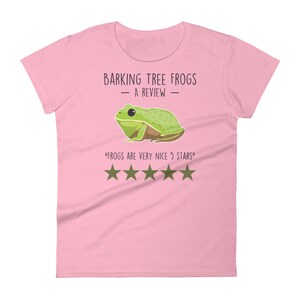 May include: Pink women's t-shirt with a green tree frog illustration and the text "Barking Tree Frogs - A Review -" and "Frogs are very nice 5 stars" with five gold stars.